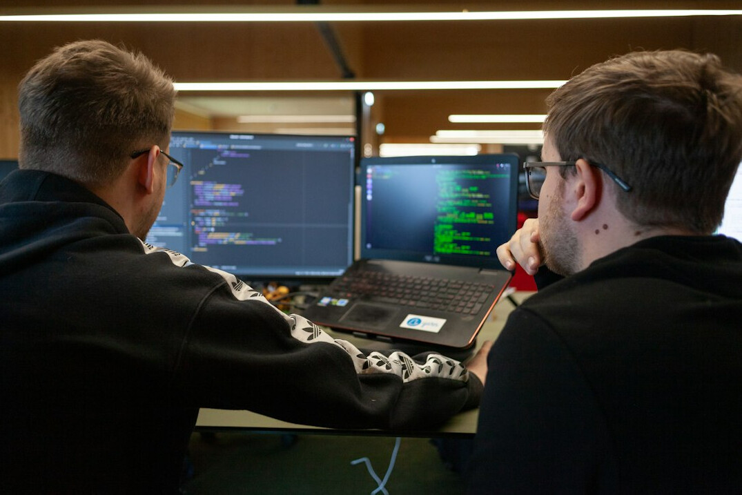 group of students discussing code