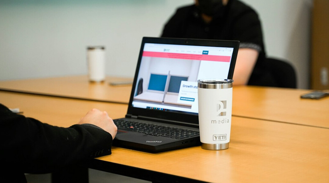 person coding on laptop at desk